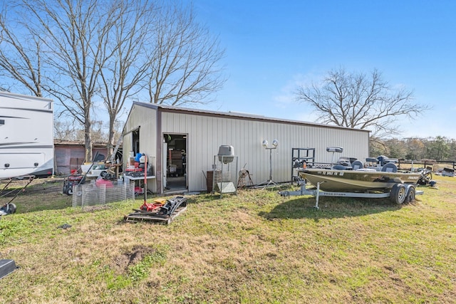 view of pole building featuring a yard and fence