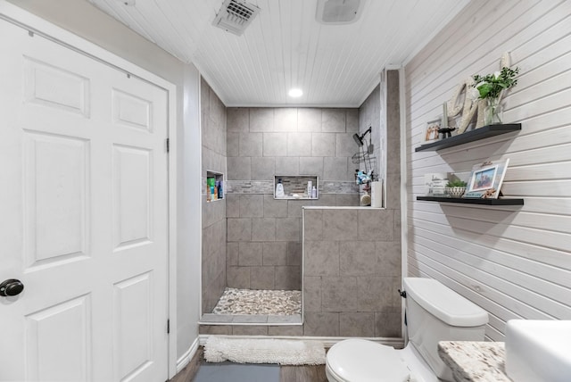 bathroom with visible vents, toilet, and a walk in shower