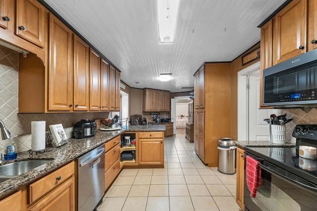 kitchen with brown cabinets, black range with electric cooktop, stainless steel dishwasher, and light tile patterned floors