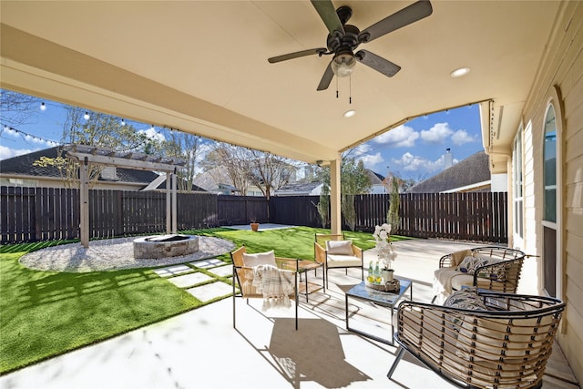 view of patio / terrace with ceiling fan, a pergola, and an outdoor living space with a fire pit