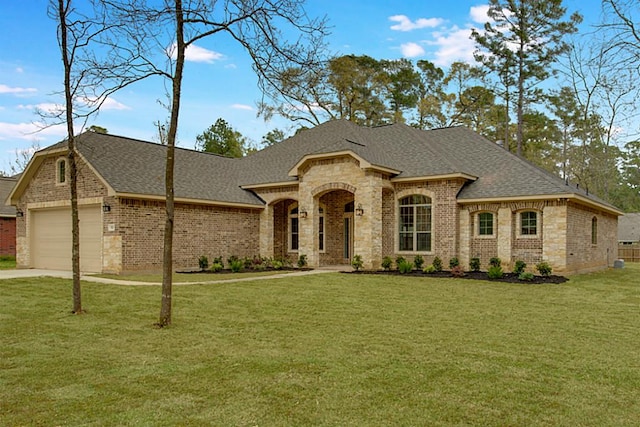 french provincial home with a garage and a front lawn