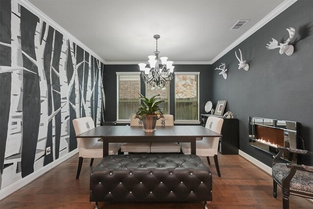 dining area featuring ornamental molding, dark hardwood / wood-style flooring, and a chandelier