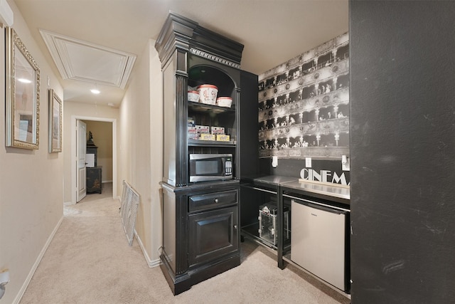 bar with refrigerator and light carpet