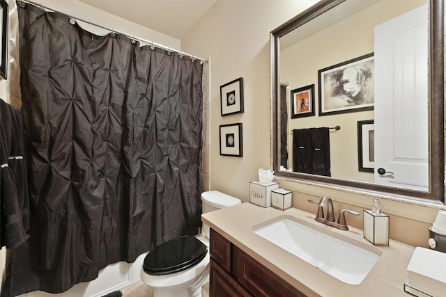 full bathroom with vanity, shower / bath combo with shower curtain, and toilet