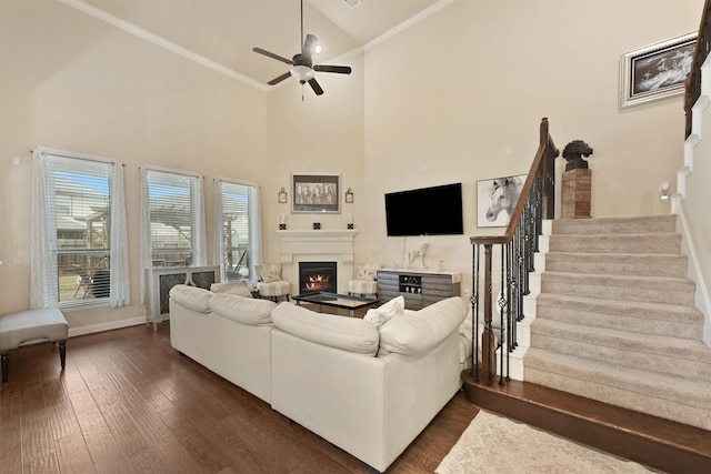 living room with crown molding, high vaulted ceiling, ceiling fan, and dark hardwood / wood-style flooring