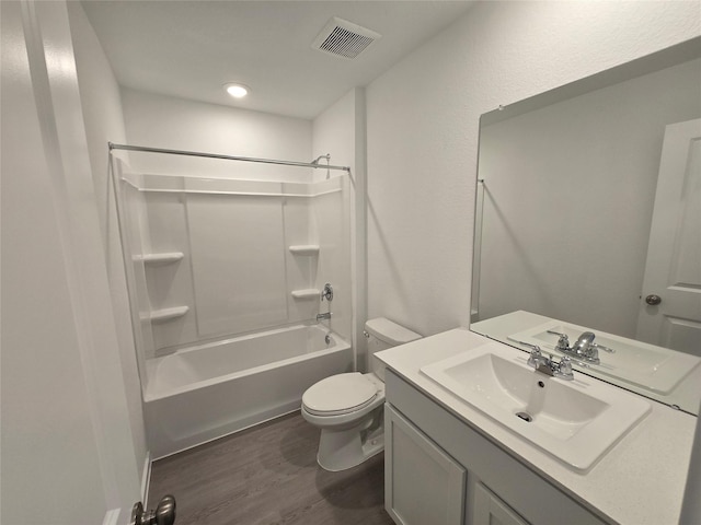 full bathroom with shower / bath combination, vanity, hardwood / wood-style floors, and toilet