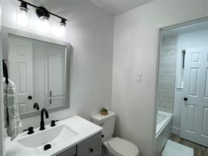 bathroom featuring toilet and vanity