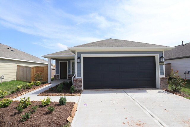 26224 Astral Way, La Marque, TX 77568 - view of front of home featuring driveway, fence, an attached garage, and a shingled roof