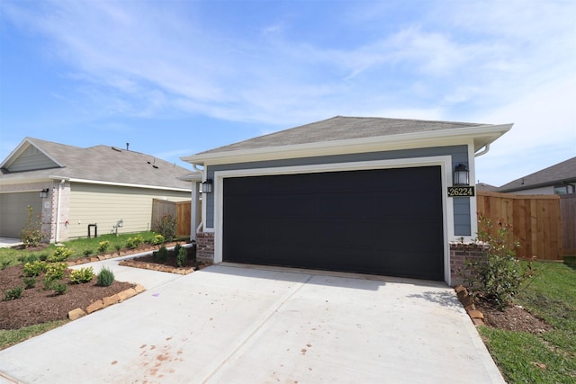 26224 Astral Way, La Marque, TX 77568 - garage featuring fence and concrete driveway