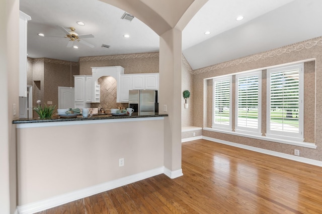 kitchen featuring kitchen peninsula, white cabinets, ceiling fan, light hardwood / wood-style floors, and stainless steel refrigerator with ice dispenser