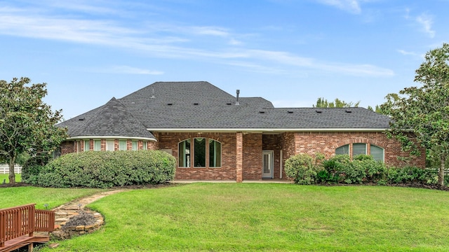 rear view of property with a lawn