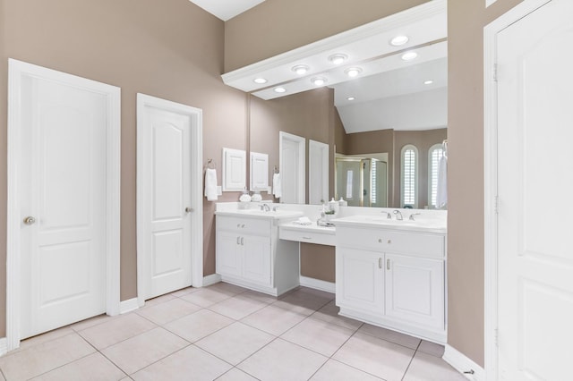 bathroom with tile patterned flooring, vanity, vaulted ceiling, and a shower with shower door