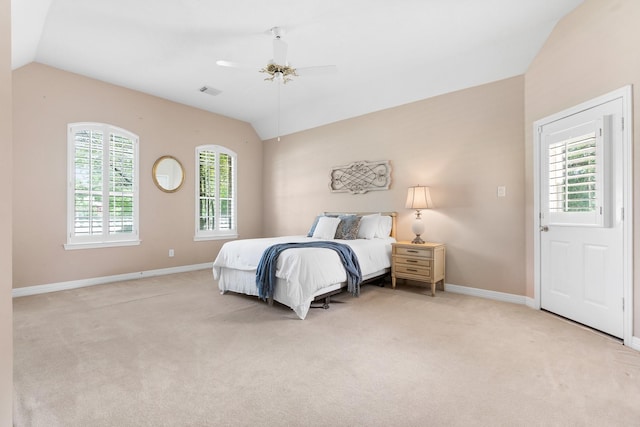 bedroom with vaulted ceiling, light carpet, and ceiling fan