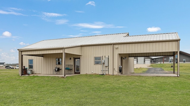 rear view of property featuring a lawn