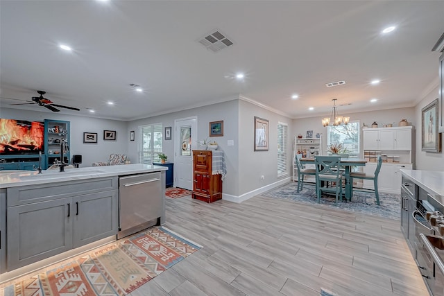 kitchen featuring sink, decorative light fixtures, stainless steel dishwasher, ornamental molding, and gray cabinets