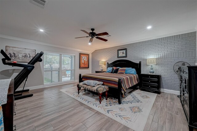 bedroom featuring ornamental molding, light hardwood / wood-style floors, ceiling fan, and brick wall