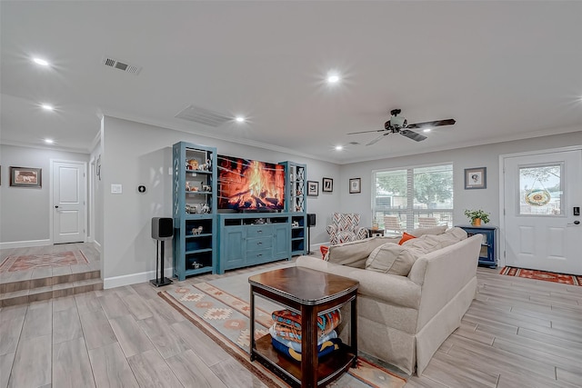 living room featuring ornamental molding and ceiling fan