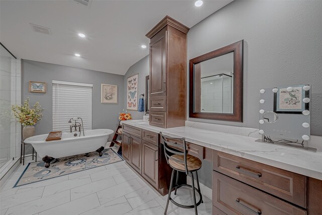 bathroom featuring vanity and independent shower and bath