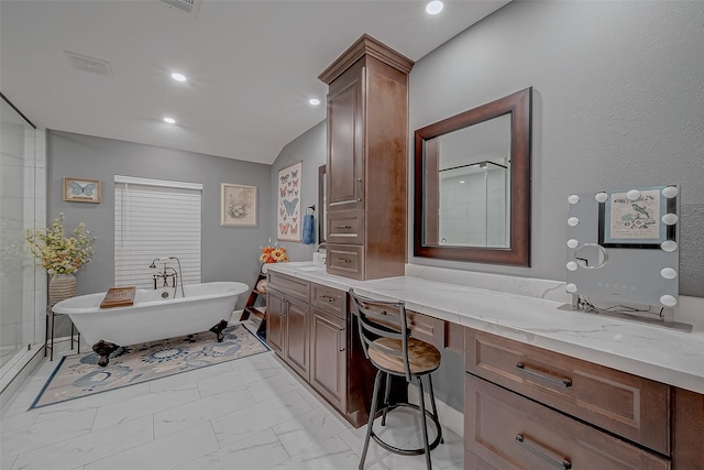 bathroom with vanity and shower with separate bathtub