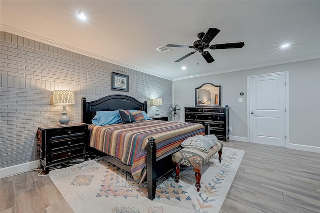 bedroom featuring ceiling fan, brick wall, ornamental molding, and light hardwood / wood-style flooring