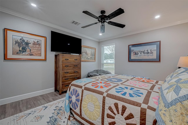 bedroom featuring crown molding, ceiling fan, and light hardwood / wood-style floors