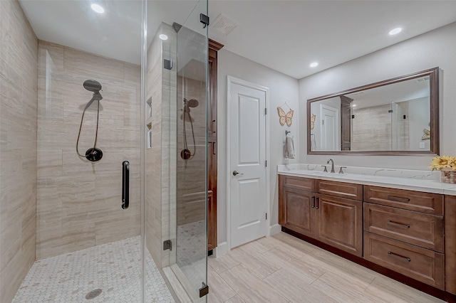 bathroom with vanity and an enclosed shower