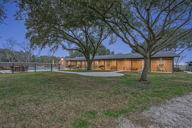 view of yard featuring a fenced in pool and a patio