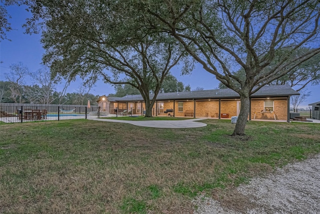 view of yard with a fenced in pool and a patio