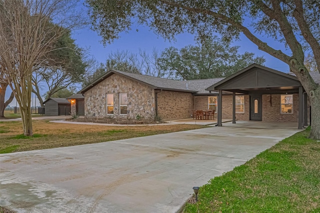 ranch-style house featuring a carport and a front lawn