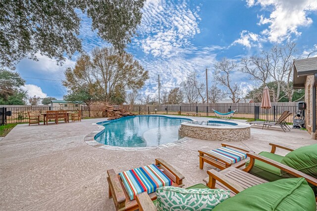 view of pool with outdoor lounge area, a patio, and an in ground hot tub