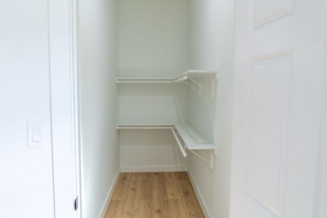 spacious closet with light hardwood / wood-style floors