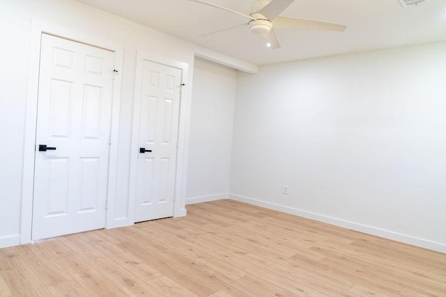 spare room featuring ceiling fan and light hardwood / wood-style flooring