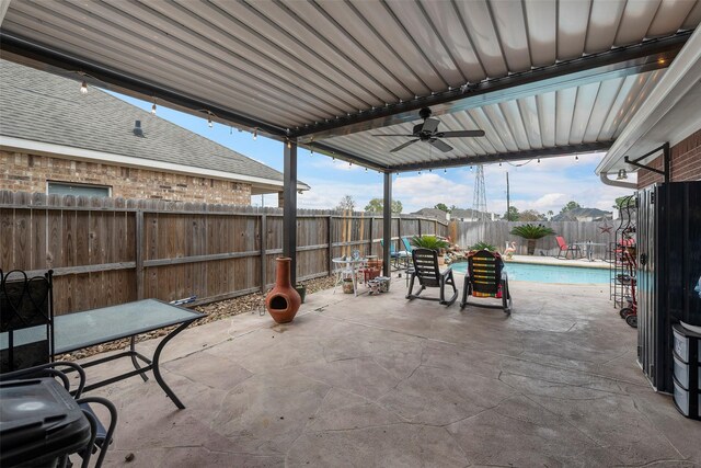 view of patio featuring a fenced in pool and ceiling fan