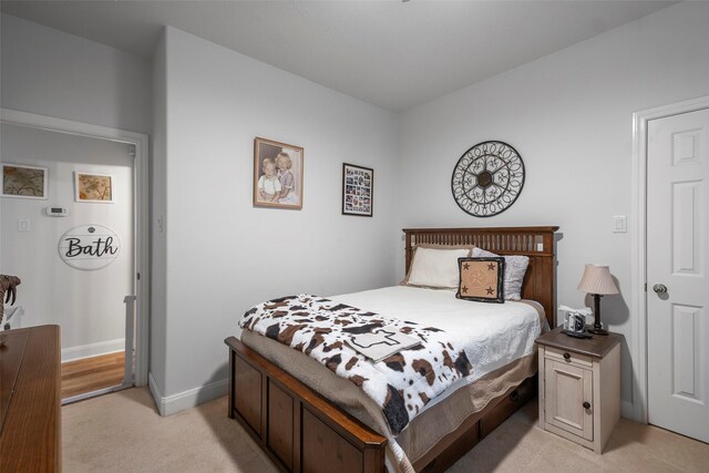 bedroom featuring light carpet