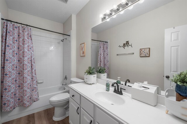 full bathroom with vanity, wood-type flooring, toilet, and shower / bath combo with shower curtain