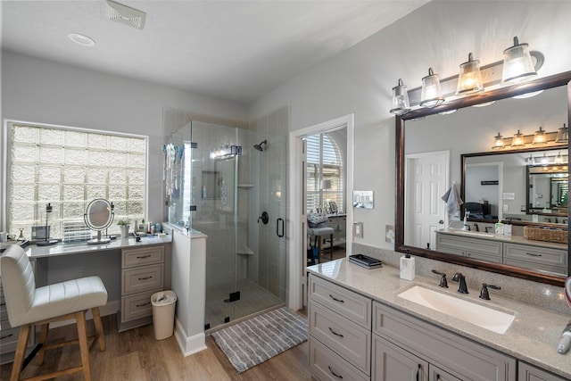 bathroom featuring vanity, a shower with shower door, and hardwood / wood-style floors