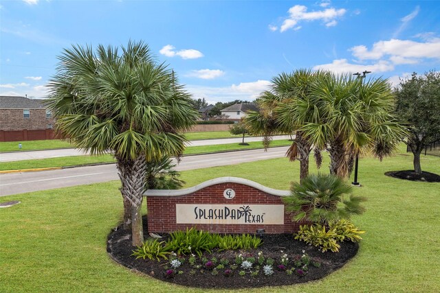 community sign featuring a yard