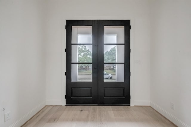 entryway featuring light hardwood / wood-style flooring and french doors