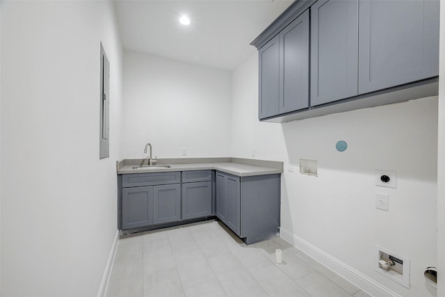 clothes washing area with hookup for a washing machine, electric dryer hookup, sink, and cabinets