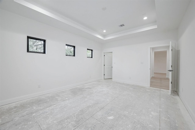 empty room featuring a tray ceiling