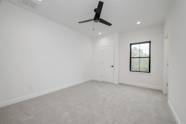 carpeted spare room featuring ceiling fan