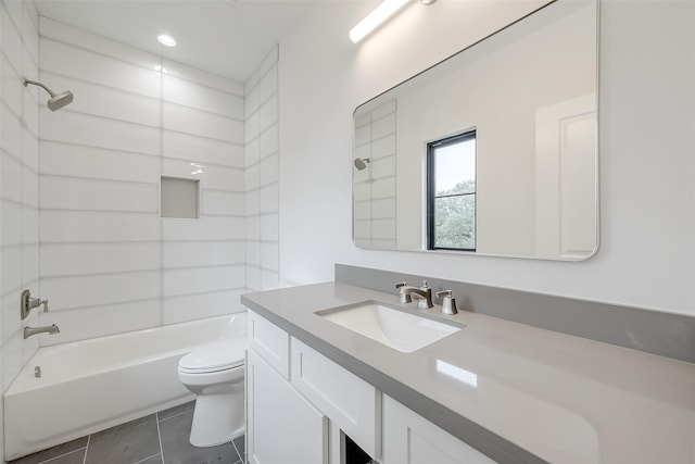 full bathroom with vanity, tile patterned floors, toilet, and tiled shower / bath