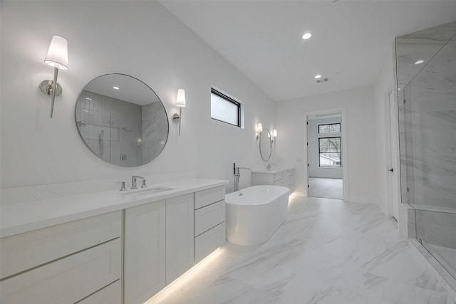 bathroom featuring vanity and independent shower and bath