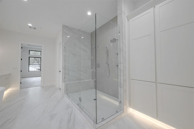 bathroom featuring a shower with shower door