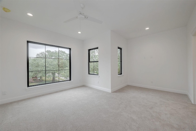 carpeted spare room with ceiling fan