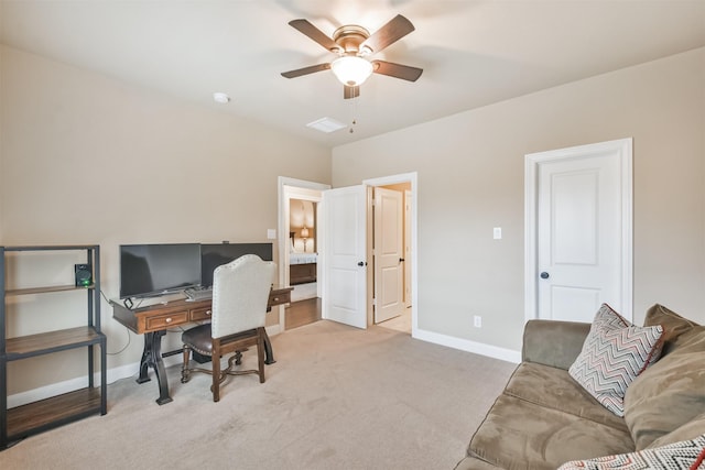 carpeted office space featuring ceiling fan