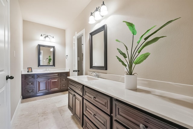 bathroom with tile patterned floors and vanity