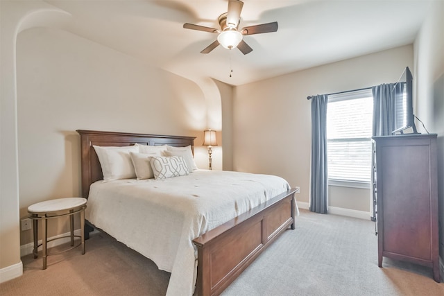 bedroom featuring light carpet and ceiling fan