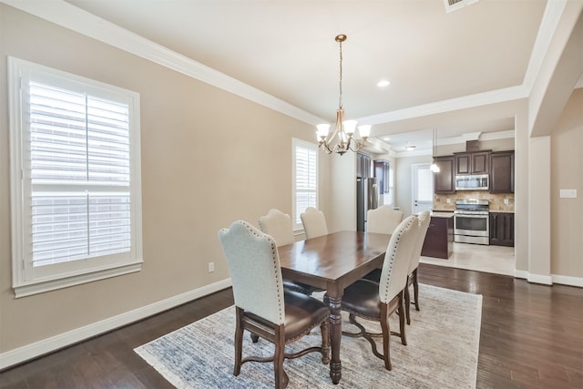 dining space featuring ornamental molding, dark hardwood / wood-style floors, and a chandelier