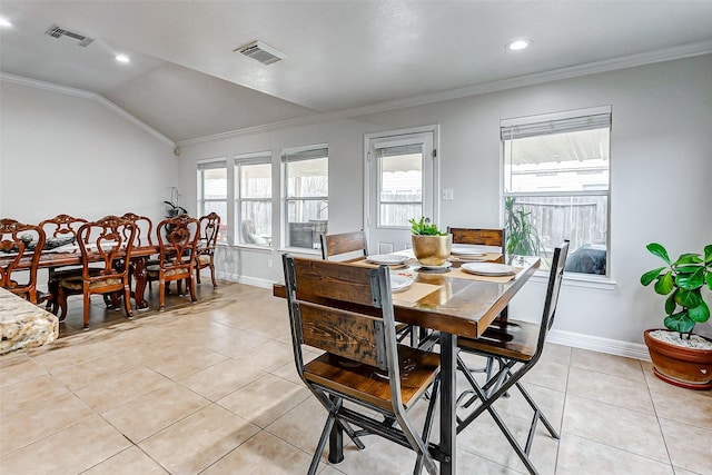 tiled dining room with crown molding and vaulted ceiling